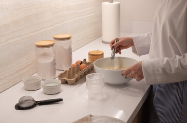 Woman at home in her kitchen cooking, woman hands, culinary blog, step-by-step recipe for cooking a dish, breakfast , recipe, plate and whisk for preparing breakfast