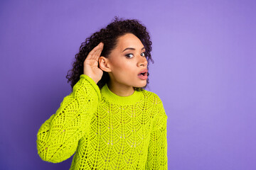 Closeup photo of young funny excited girl with curly hair touching ear trying to hear breaking news...