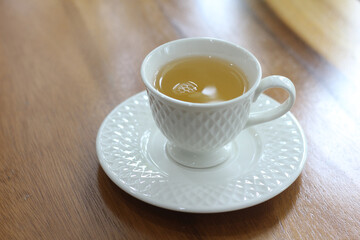 cup of tea on wooden table in coffee shop