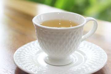cup of tea on wooden table in coffee shop