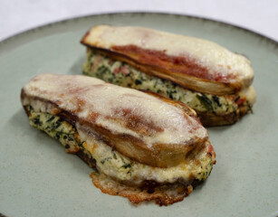 Healthy eating. Closeup view of stuffed zucchinis with ricotta, kani kama, spinach and gratin cheese