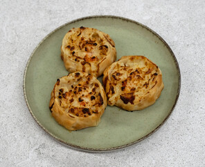 Gourmet seafood. Closeup view of open shrimps empanadas with gratin cheese in a dish