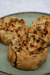 Gourmet seafood. Closeup view of open shrimps empanadas with gratin cheese in a dish