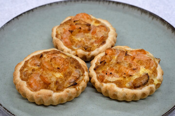 Seafood and bakery. Closeup view of three shrimp pies with gratin cheese