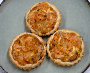 Seafood and bakery. Top view of three shrimp pies with gratin cheese