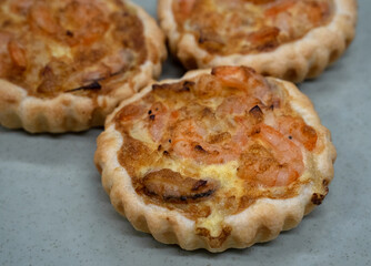Seafood and bakery. Closeup view of a shrimp pie with gratin cheese