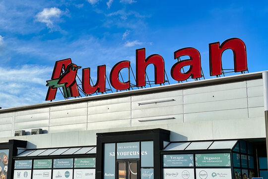 Lille, France - April 12 2023: the big auchan sign has been placed on top off a location of the grocery store chain property