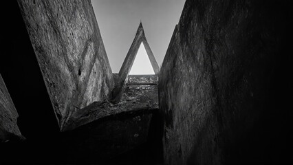 Generative AI, Dark, dramatic black-and-white architectural photograph of towering concrete walls with minimal light and sharp geometric contrasts