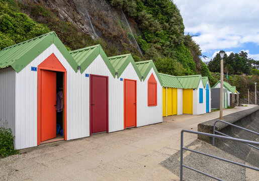 Colorful beach huts along a seaside promenade in Binic, Brittany