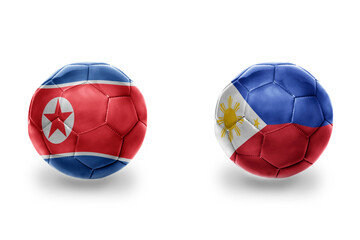 Fototapeta premium football balls with national flags of philippines and north korea ,soccer teams. on the white background.