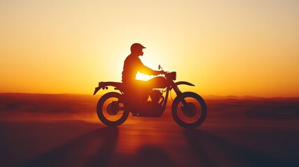 A silhouette of a motorcyclist riding against a stunning sunset backdrop, capturing the spirit of freedom and adventure.