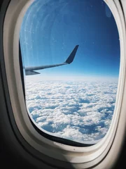 Rolgordijnen zonder boren View from a plane of the wing over the clouds © brienhop