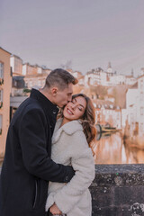 a joyful couple walking through a charming European city in winter. Wedding, love, street style