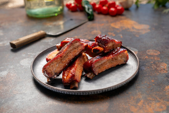 Smoked bbq ribs cooked on a grill with BBQ sauce 
