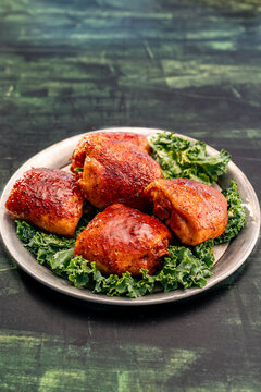 Smoked chicken thighs cooked on a gill with BBQ sauce 