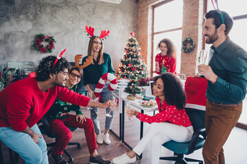 Photo of cheerful young people colleagues toast champagne have fun cozy christmas party decor...