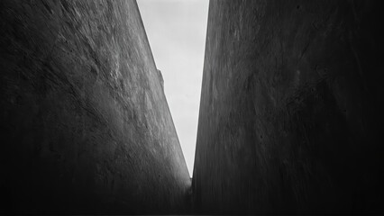 generative ai, Dark, dramatic black-and-white architectural photograph of towering concrete walls with minimal light and sharp geometric contrasts
