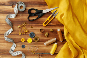 Crafting tools and materials arranged on a wooden table ready for sewing and creative projects