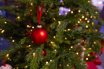 Christmas bauble On Christmas Tree With traditional Ornaments, christmastime Moments, blur festive background, Bokeh effect garlands