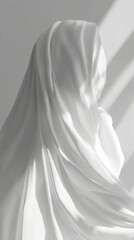 Explore the beauty of elegant white silk fabric draped with graceful folds and shadows