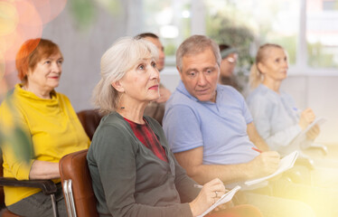 Group of mature students attending lecture in college