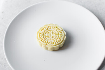 Overhead view of tuwon madara on a white plate, nigerian alawar madara milk candy, top view of milk...