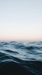 Obraz premium Experience the tranquil beauty of the dusk horizon over the sea with a vast open sky