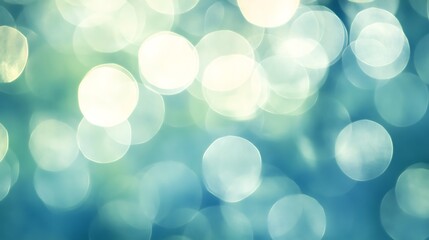 Fototapeta premium Abstract bokeh background with soft blue and green circles, evoking a Christmas or springtime feel