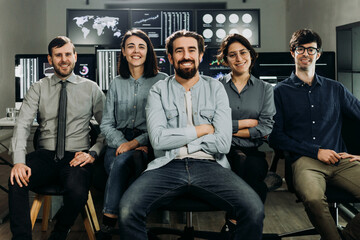 Diverse team of stock traders posing confidently in their control room. Financial investment and...
