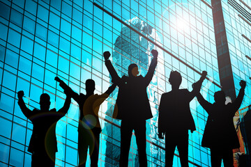Silhouettes of six businessmen with arms raised in celebration in front of a large office building.