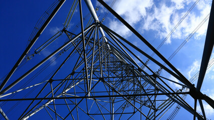 A huge steel tower towering high in the sky and white clouds flowing in the blue sky