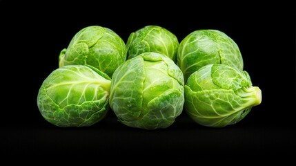 Fototapeta premium Fresh Green Brussels Sprouts on Black Background Healthy Food Vegetable Diet Cooking