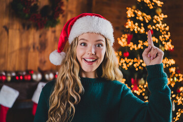 Photo of nice teen girl point finger up eureka wear green christmas clothes enjoy modern cozy x-mas...