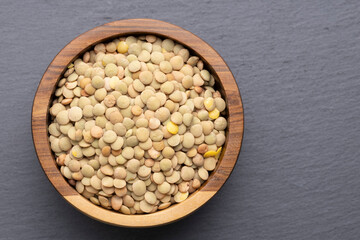 Green Lentils In Wooden Bowl On Gray Surface