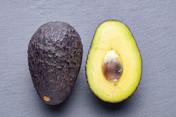 Ripe Avocado Halves on Grey Slate Background