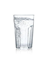 Pouring soda water from bottle into glass on white background
