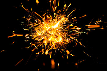 Bengal fire spark. New year spark isolated on black background. Light spark effects. Sparkle backdrop. Sparkler firework or Spark lights.