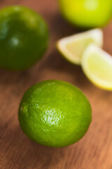 Fresh Whole Key Lime on Wood