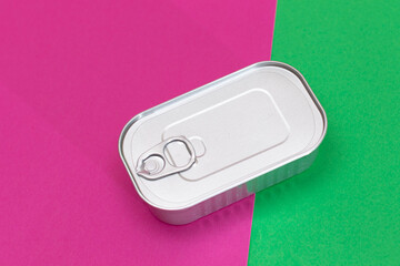 Tin Can on Split Green and Cyan Background. Canned Food. Aluminum Can for Safe and Long Term Storage of Food. Steel Sealed Food Storage Container