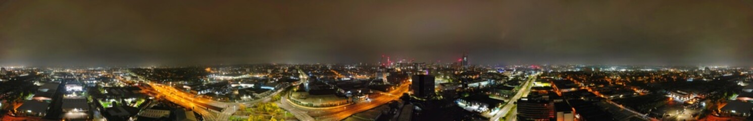 Obraz premium Aerial Panoramic View of Illuminated Downtown Buildings at Central Birmingham City Centre During Night at Midlands, England, United Kingdom. Drone's Camera Footage was Captured on November 4th, 2024.