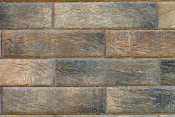 A brick wall with a brown and tan color