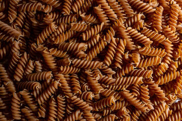 Uncooked Whole Grain Fusilli Pasta: A Culinary Canvas of Whole Wheat Spirals, Creating a Lively and...