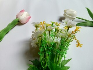 Artificial decorative flowers on white background.