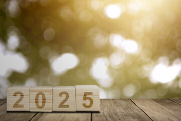 Wooden blocks with number 2025 and abstract bokeh lights background