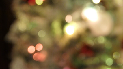 Out of focus blurred Christmas bobbles and decorations on a tree