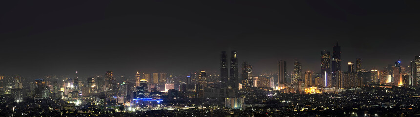 Obraz premium Panorama view of modern building skyscrapers and futuristic architecture with night scene