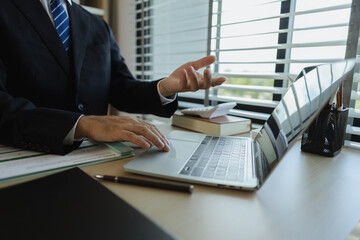 A businessman is presenting an earnings report to the board of directors with great attention. Data and documents are presented and explained in the meeting by a businessman.