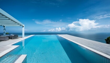 Fototapeta premium A luxury hotel infinity pool with the ocean at its edge