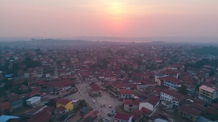 Fototapeta premium Aerial View of Urban Sunset Over a Vibrant Township