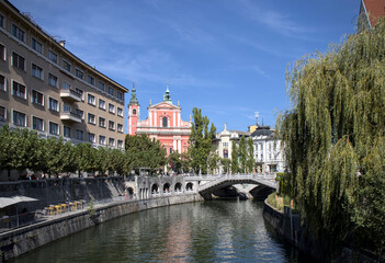 View of pink church in downtown Ljubljana, Slovenia, Europe from the river downtown.